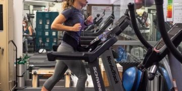 Woman running on treadmill in gym