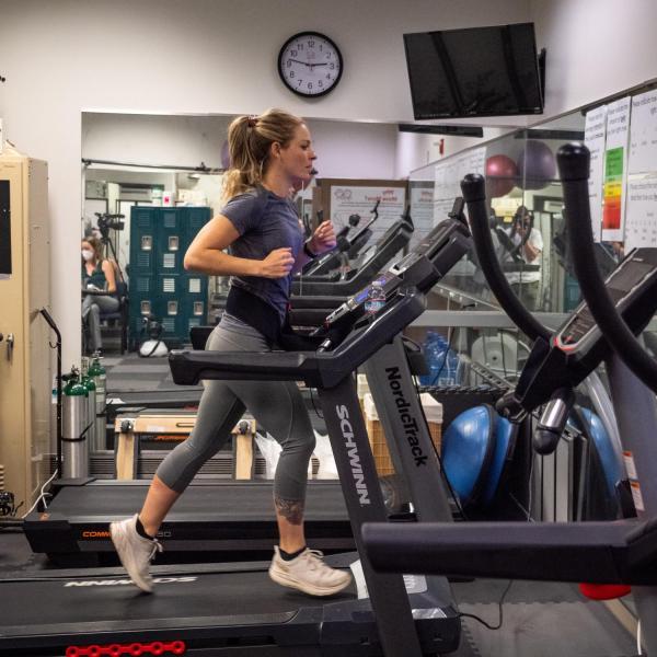 Woman running on treadmill in gym