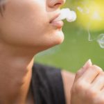 Person smoking outdoors in daytime