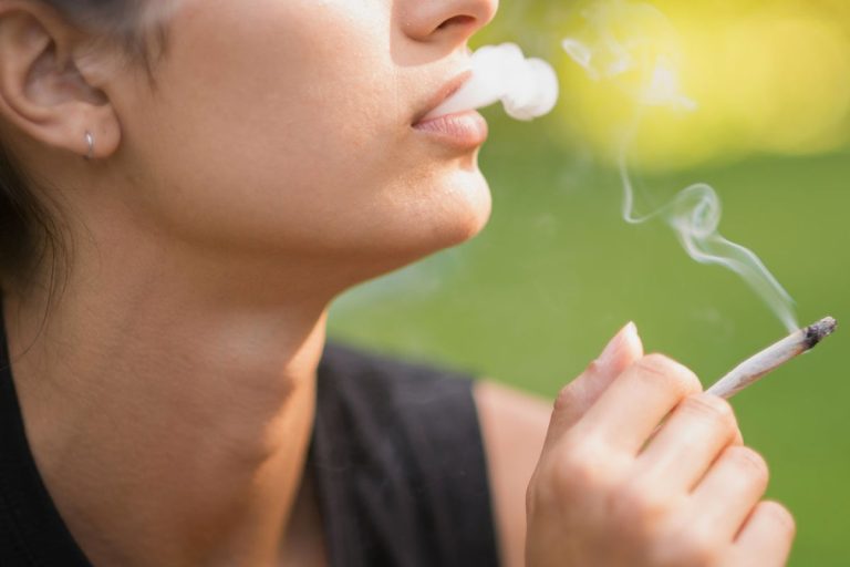 Person smoking outdoors in daytime