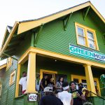 GreenHop store exterior with group of people gathering