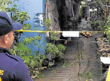 Crime scene with police caution tape and alleyway.