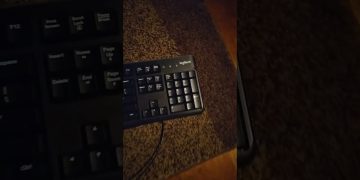 Black Logitech keyboard on brown carpet