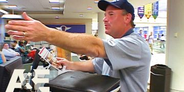 Airport staff assisting traveler at check-in desk