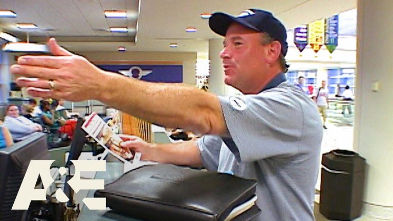 Airport staff assisting traveler at check-in desk