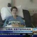 Smiling patient in hospital bed with Hopkins shirt.