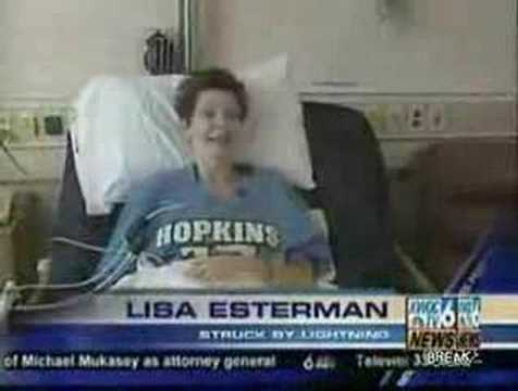 Smiling patient in hospital bed with Hopkins shirt.