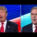 Two men in suits during a debate.