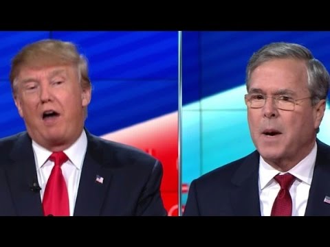 Two men in suits during a debate.