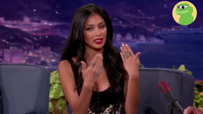 Woman speaking on talk show, gesturing with hands.