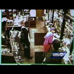 CCTV footage of people in a store aisle.