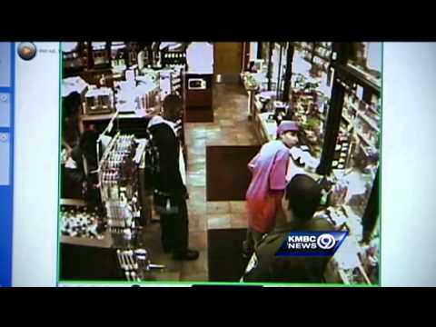 CCTV footage of people in a store aisle.