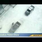 Aerial view of Canadian police chase in snow.