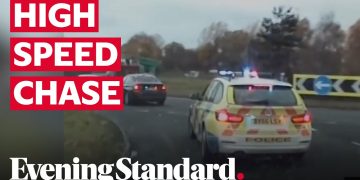 Police car in high-speed chase on highway.