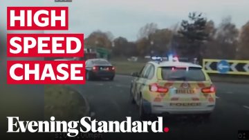 Police car in high-speed chase on highway.