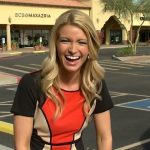 Woman laughing outside a shopping center