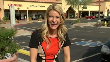 Woman laughing outside a shopping center