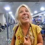 Smiling woman in airport terminal.