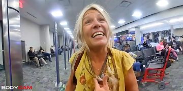 Smiling woman in airport terminal.