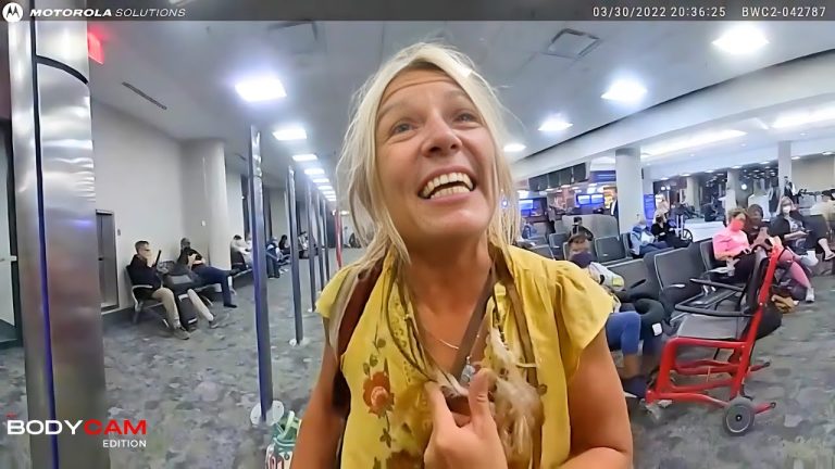 Smiling woman in airport terminal.