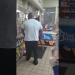 People inside a convenience store near the counter.