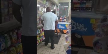 People inside a convenience store near the counter.