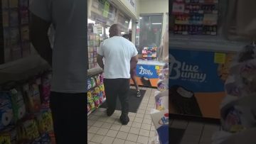 People inside a convenience store near the counter.