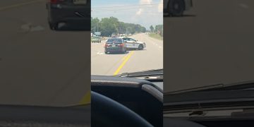 Police car stops vehicle on highway