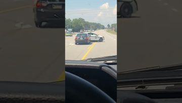 Police car stops vehicle on highway