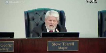 Man speaking at a council meeting.