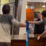 Two people arguing at a restaurant counter.