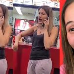 Woman on phone at fast food counter, smiling face.