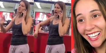 Woman on phone at fast food counter, smiling face.