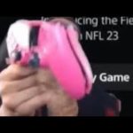 Person holding pink gaming controller.