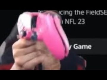 Person holding pink gaming controller.