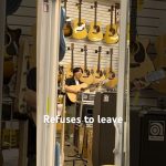 Person playing guitar in a music store