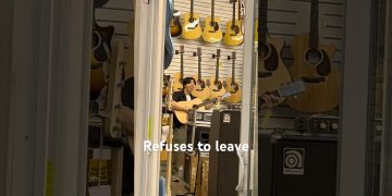 Person playing guitar in a music store