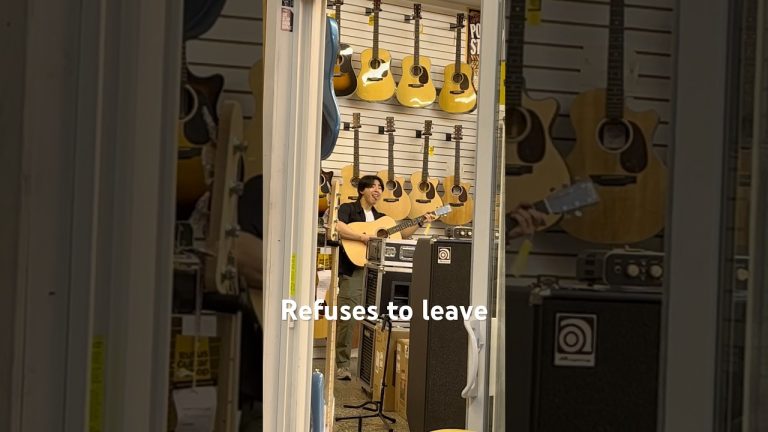 Person playing guitar in a music store