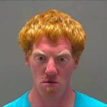 Man with red hair and teal shirt.