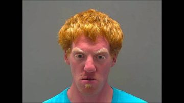 Man with red hair and teal shirt.