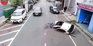 Car crash with overturned vehicle on city street.