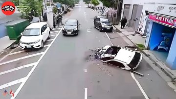 Car crash with overturned vehicle on city street.