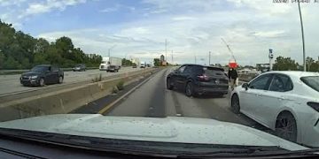 Highway accident scene with multiple cars involved.