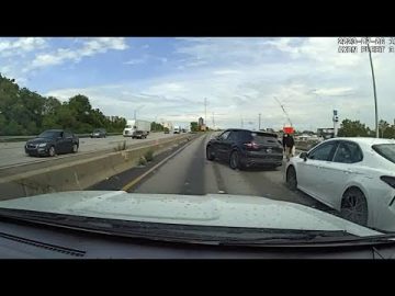 Highway accident scene with multiple cars involved.