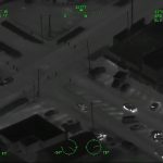 Aerial night vision of city intersection with vehicles.