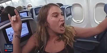 Woman angrily gesturing on airplane.