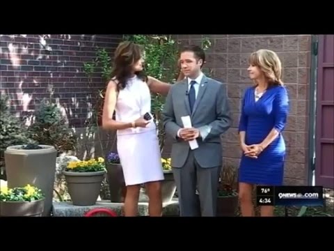 Three news anchors standing outside on 9NEWS set.