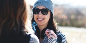 Smiling woman in sunglasses and gray beanie