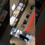 Fast food counter with menu boards and staff.