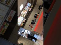 Fast food counter with menu boards and staff.